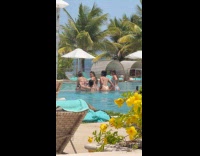 Four women sits for back pool photo