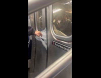 Plastic bag with box stuck outside train doors