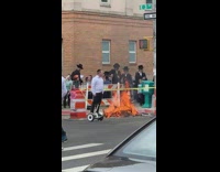Guy on hoverboard by fire in street