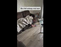 Guy on couch fell asleep on phone 