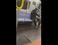 Guy riding subway is wearing halloween mask 