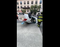 White car flipped over on the road