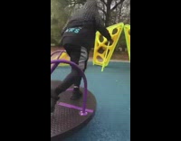 Girl falls off black purple playground spinner