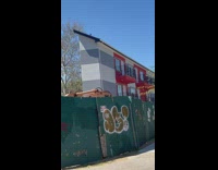 Filmer driving on street records a tiny new apartment building