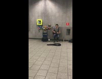 Guy striped shirt singing somewhere over the rainbow green bowls next to him