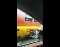 Hotdog shaped car wait at the stoplight