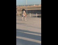 Woman in gray sweater and skirt tiktok dance near the France Flag