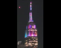 Empire state building with colorful rainbow lights 