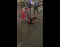 Two girls hug behind dogs street christmas