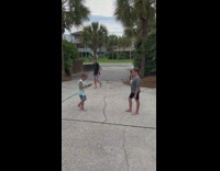Little girl poses while another little girl takes her picture