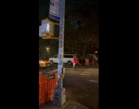 Man holds stick with cup begging money