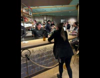Woman film starbucks employee serve her drink