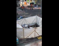 2 people work in white tent 