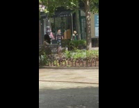 Lady dances sidewalk green scarf dog leash