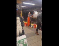 Guy plays buckets as drum 