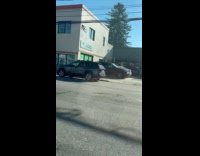 Guy white jacket drives motorcycle on sidewalk