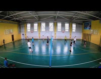 Guy serves volleyball into basket 