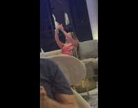 Girl take selfies on sofa bar  man laughs