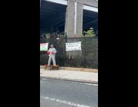 Guy wear prison uniform and dance at highway 