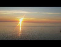 Pink yellow sunset over blue ocean water