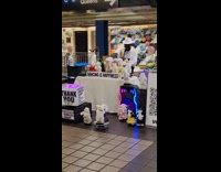 Man plays saxophone toys dance at subway