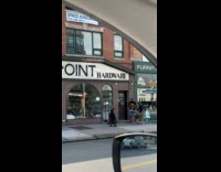 Video shoot of man dancing beside hardware store