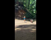 Woman in sports bra blue shorts poses at the river