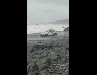 Ocean waves hit parked white car fail