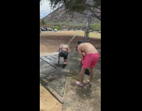 Woman in bikini under the shower water and poses