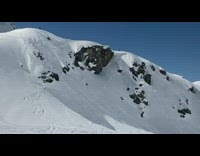 far shot of snowboarder going down mountain
