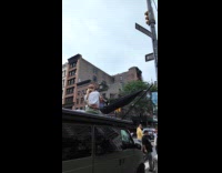 Collab WINY - Couple sets up hammock on top of van