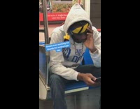 man yellow bandana grey sweater sucking thumb