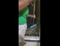 Woman sweeps flood outside of home into basement