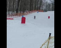 Skier goes up in air and lands on back
