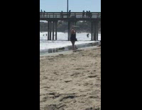 Girl black dress dance spin hoop beach