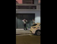 Two women tiktok dance on the sidewalk
