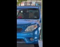 Two women smoke electronic cigarette inside the parked car