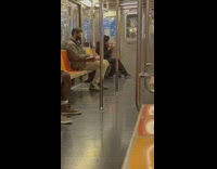 Person smoking marijuana on the subway train from a pipe 
