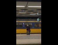 Elderly Couple Hugs One Another at Metro