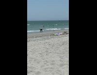 Woman fail to swing hula hoop beach