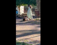 Woman in dress poses photographer lie down