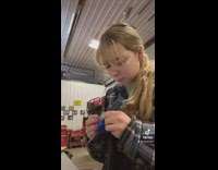 Girl testing magnetizer on screwdriver 
