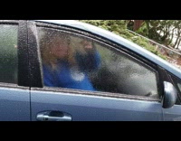 Man use head break ice formed on car window