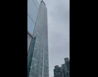Large shards of ice fall from blue nyc building