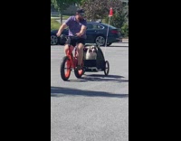 Man test E-bike with dog carrier attached