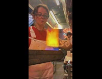 Girl in red shirt and white overalls burning glass
