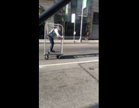 Man rides the Bellman Cart on street