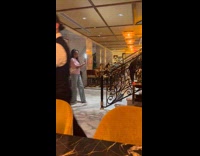 Collab IITW - Woman poses on the stairs while servers wait for them to finish