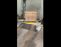 Red machine adds straps wraps cardboard box 