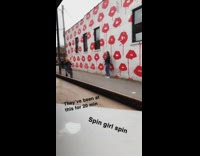 Girl black jacket spin red lips wall